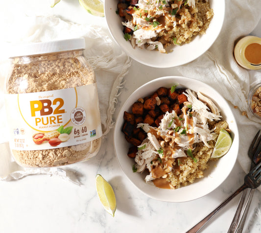 PB2 Pure jar sitting next to a chicken rice and veggie bowl